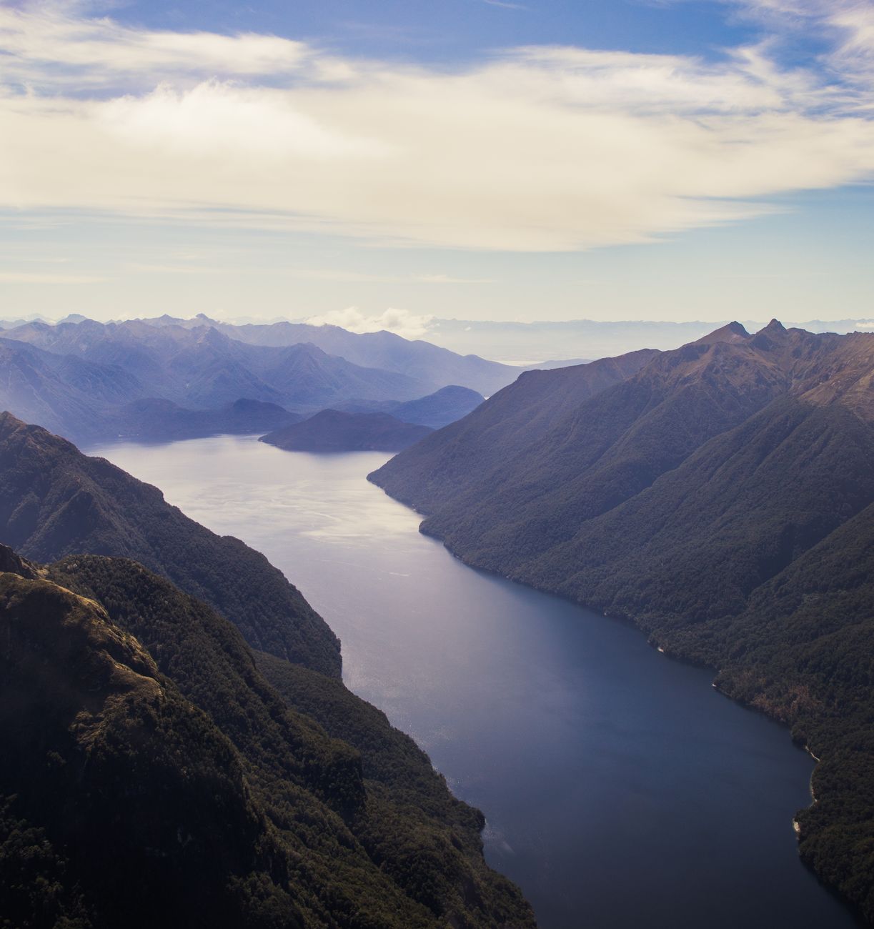 Tranquil Doubtful Sound mist shrouded mountain reflection